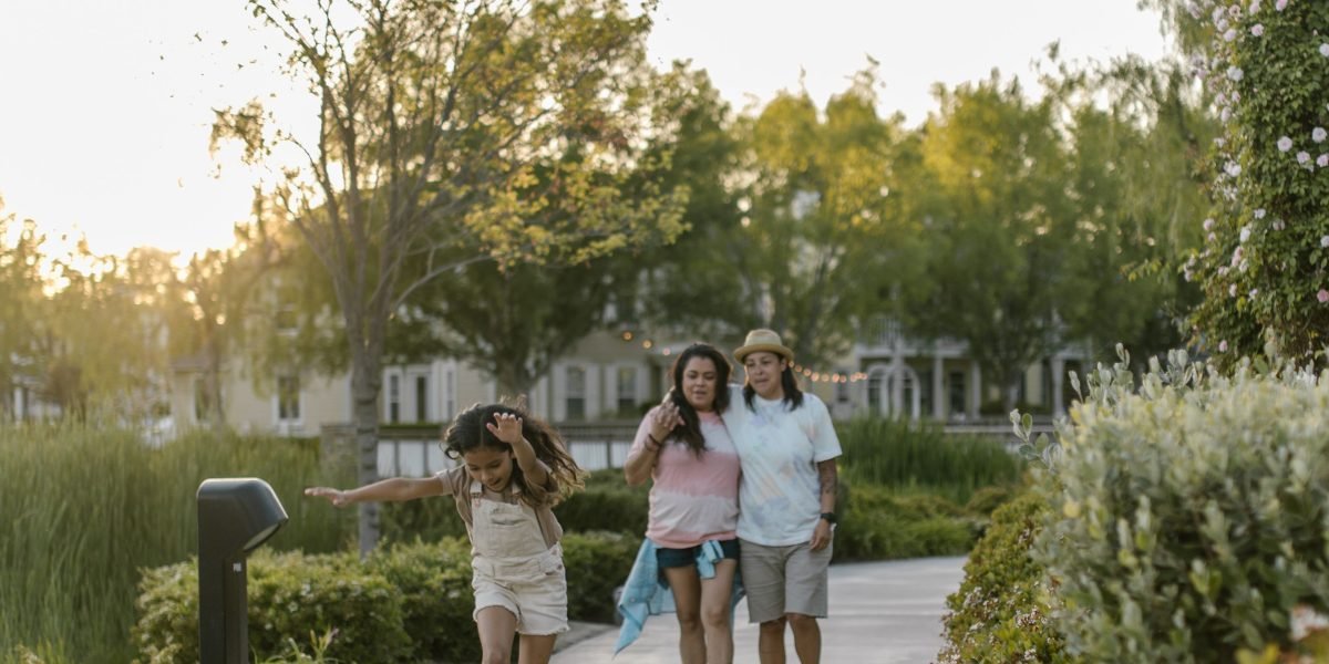 A family enjoying a modern community park, reflecting the appeal of Dubai's master-planned developments.