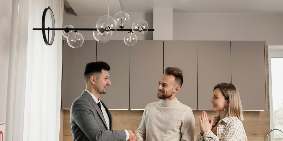 A handshake between professionals signifies the successful closing of a property transaction.
