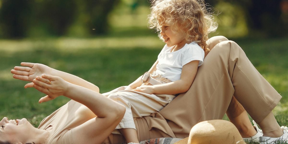 A happy family enjoying quality time together in a park, illustrating Mina Seyahi's appeal as a family-friendly community.
