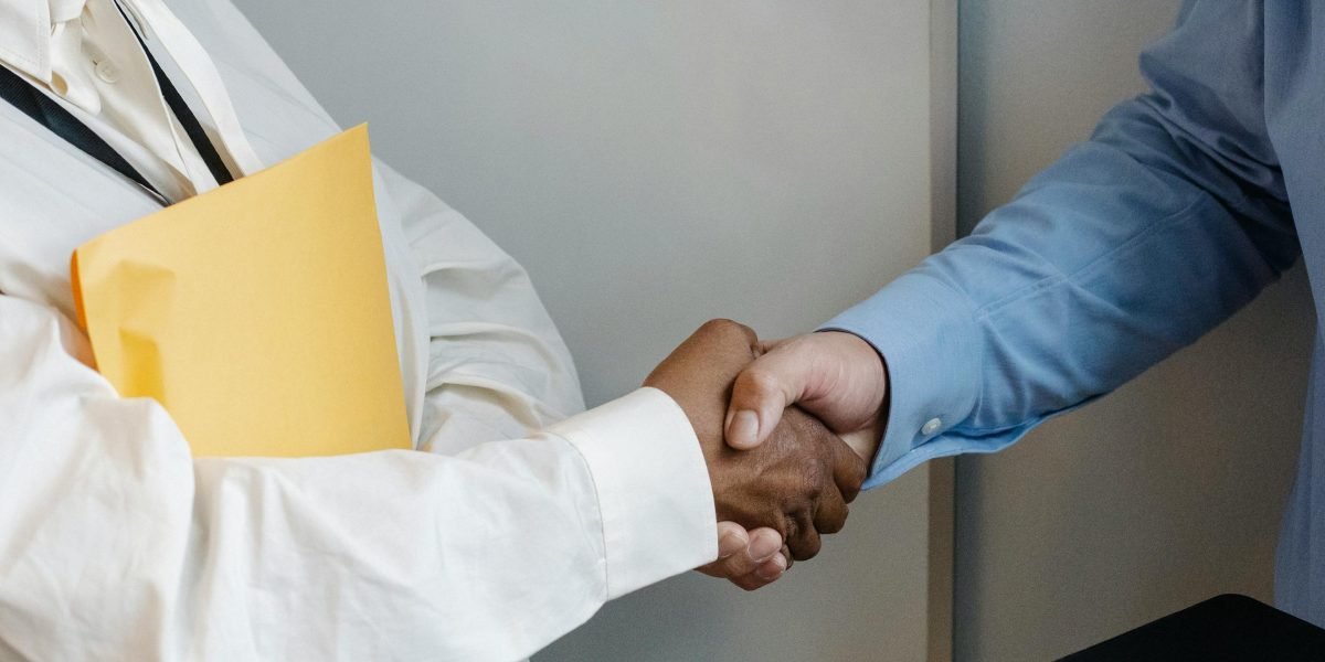 Two professionals shaking hands, symbolizing trust, agreement, and a strong business relationship after a successful meeting.
