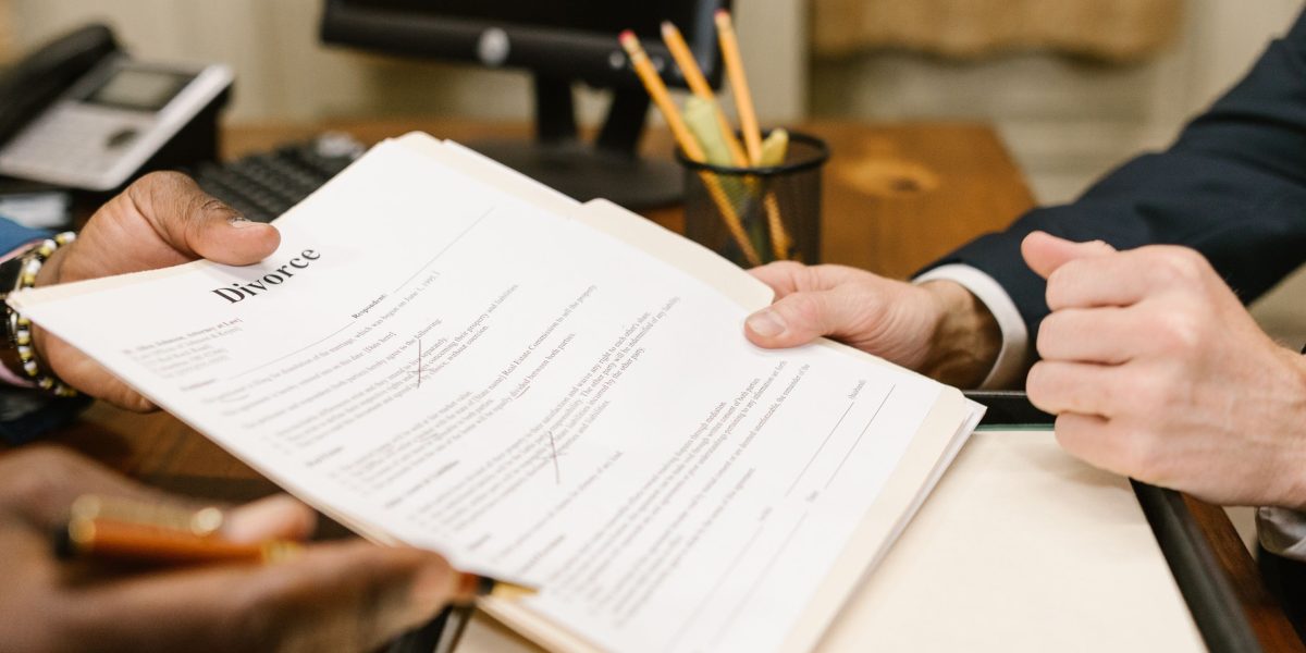 Business people reviewing and signing a contract, representing the legal finalization of a property transaction with expert guidance.