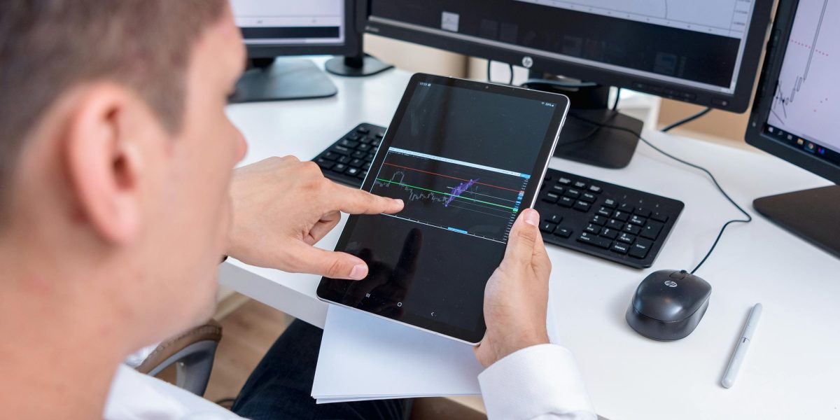 A person engaged in researching market data and trends, preparing for a significant investment.