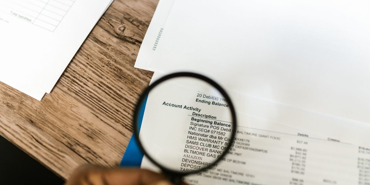 A person intently reviews financial documents, symbolizing the thorough planning required for international property investments.