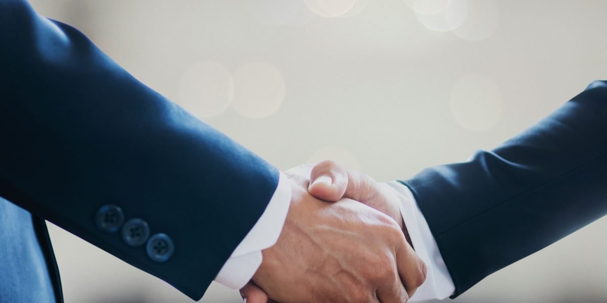 Two professionals shaking hands, signifying a successful negotiation and the conclusion of a property deal.