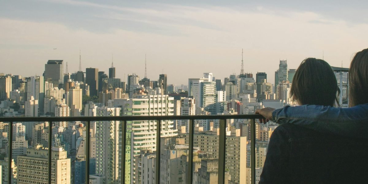 A family, parents and children, happily looking at a map or city skyline, dreaming of their new life.