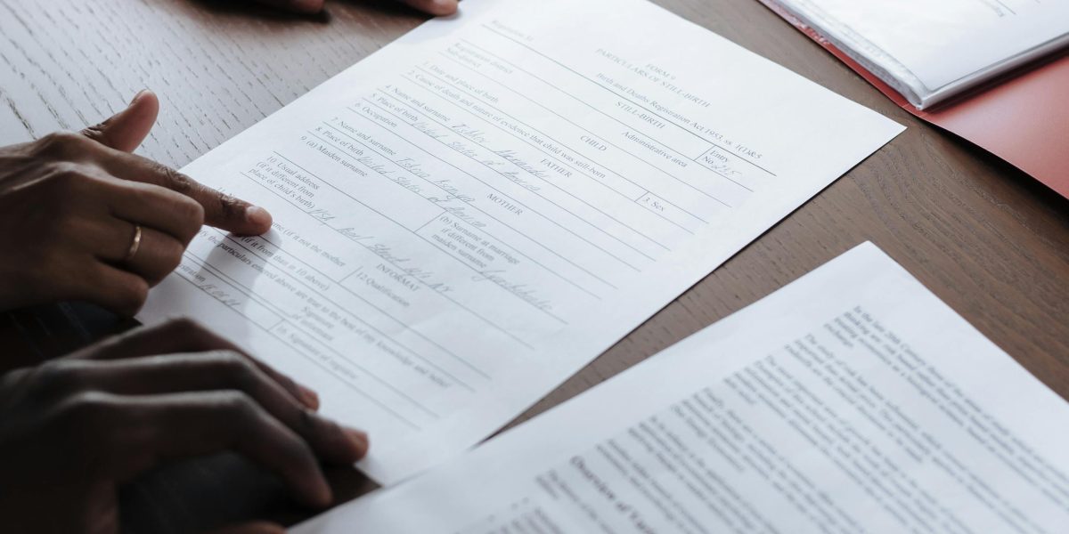 A person carefully reviewing legal documents, emphasizing the importance of understanding visa and contract terms in the UAE.
