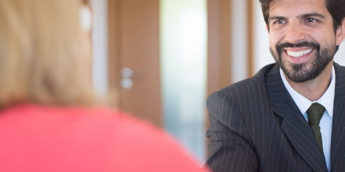 A confident individual engaged in a professional job interview, demonstrating preparedness and positive interaction.