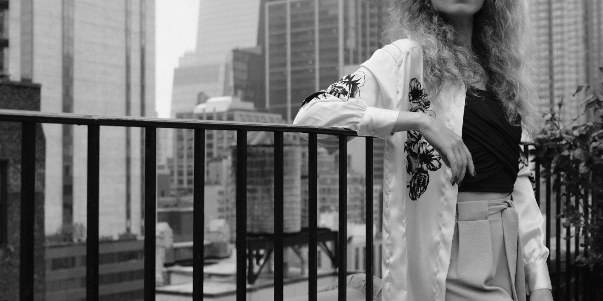 A person confidently looking towards a modern cityscape, embodying the aspiration of investing in Dubai's luxury real estate.