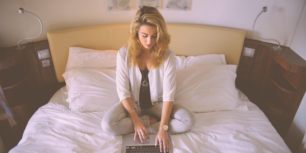 A young professional relaxing in a modern, well-designed studio apartment, highlighting comfortable compact living.