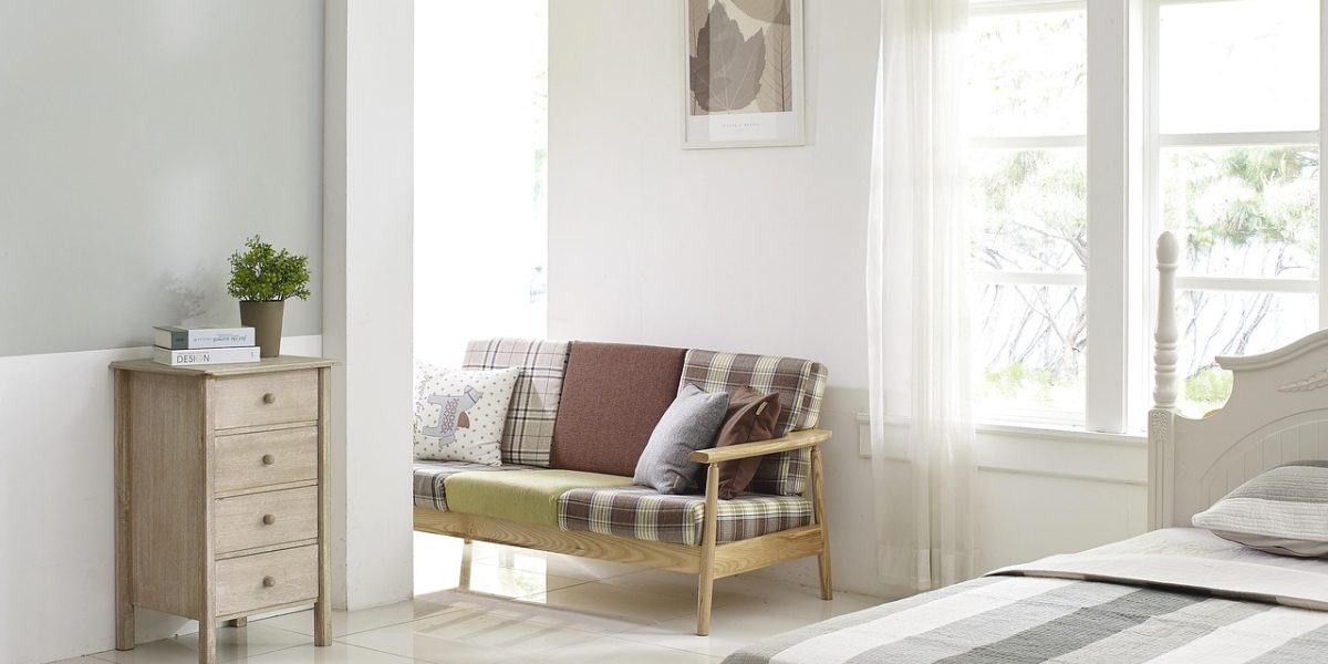 A couple enjoying their evening in a cozy living room, symbolizing comfortable shared living space in a one-bedroom flat.