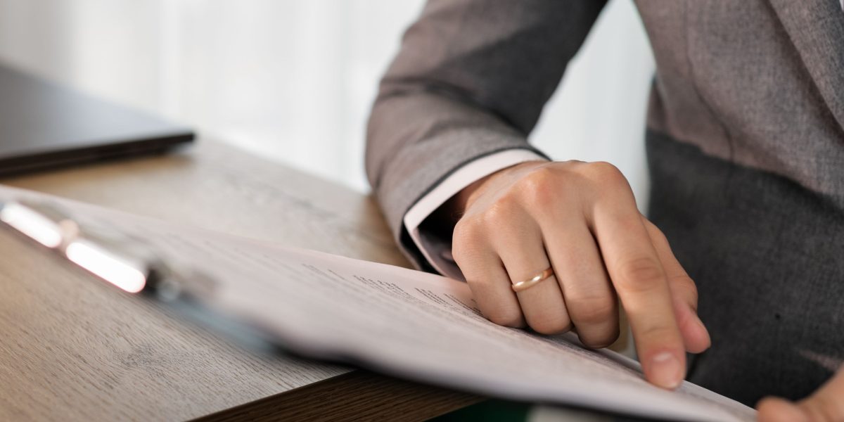 A person carefully reviewing visa applications or professional licensing paperwork for international employment.