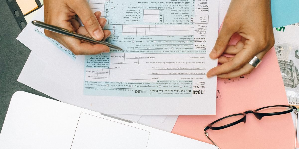 A professional carefully reviews financial documents and market data, considering investment opportunities.