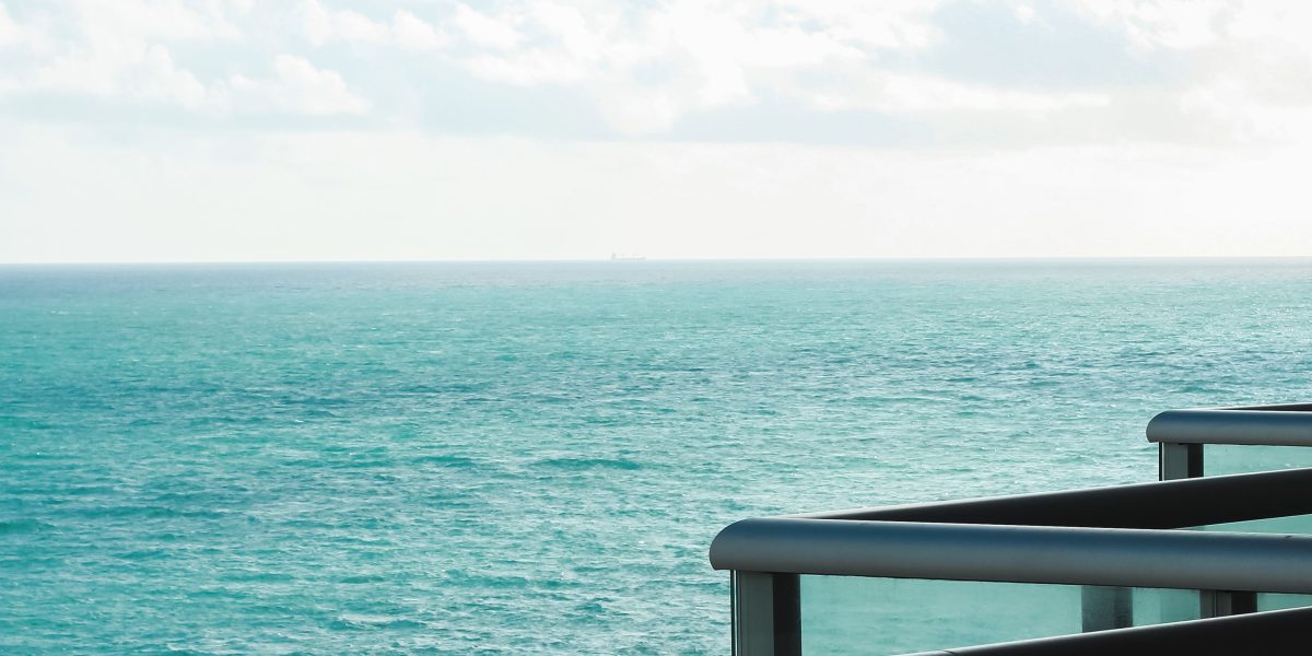 A person enjoying a breathtaking view from a luxurious terrace, embodying the dream of Dubai villa living.