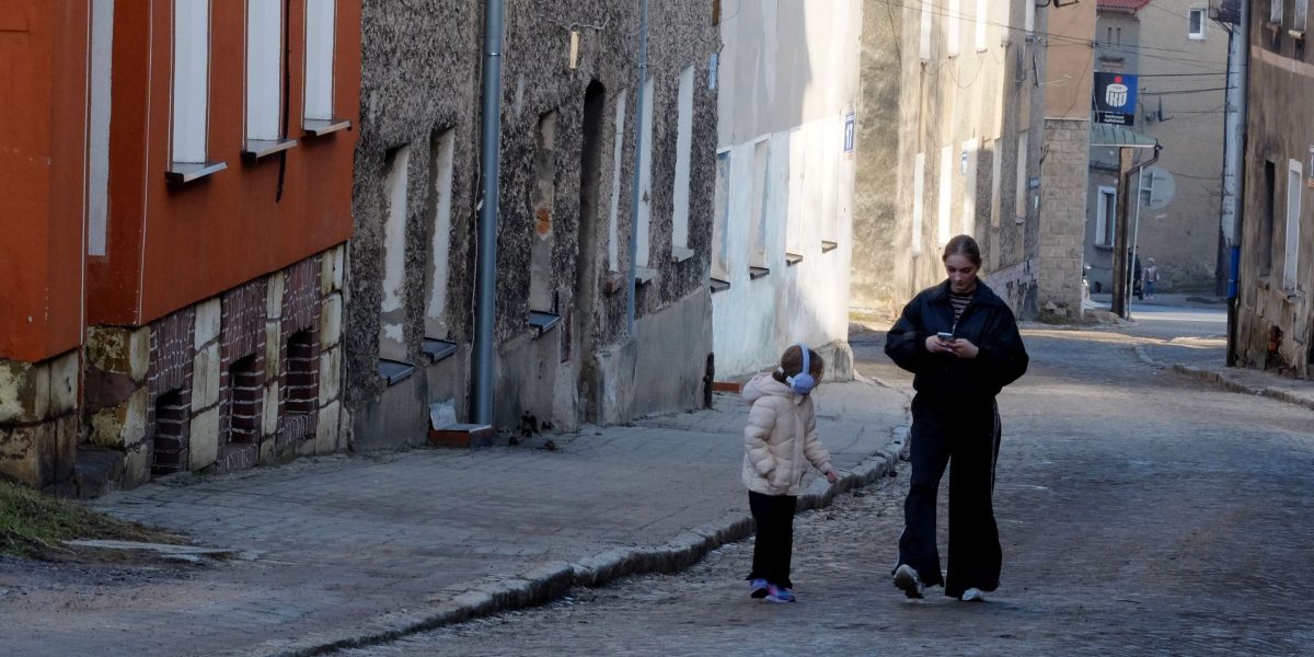 A family enjoys a leisurely walk through the charming, historic streets of Princeton.