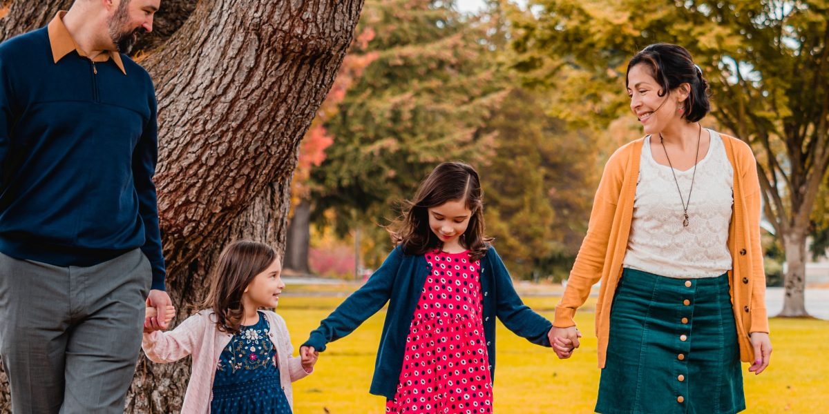 A scene depicting a family enjoying leisure time in a green park, highlighting Khalifa City's family-friendly lifestyle.