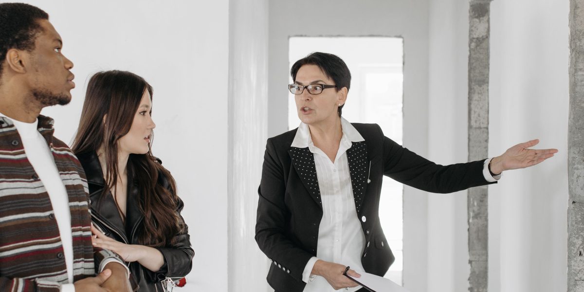 An international buyer consulting with a real estate agent about the purchase process.