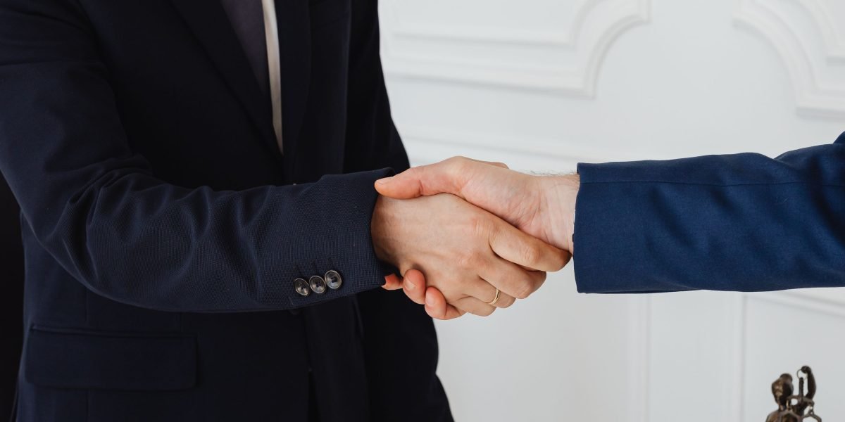 Finalize important legal agreements with a professional handshake, marking a significant step in your property purchase.