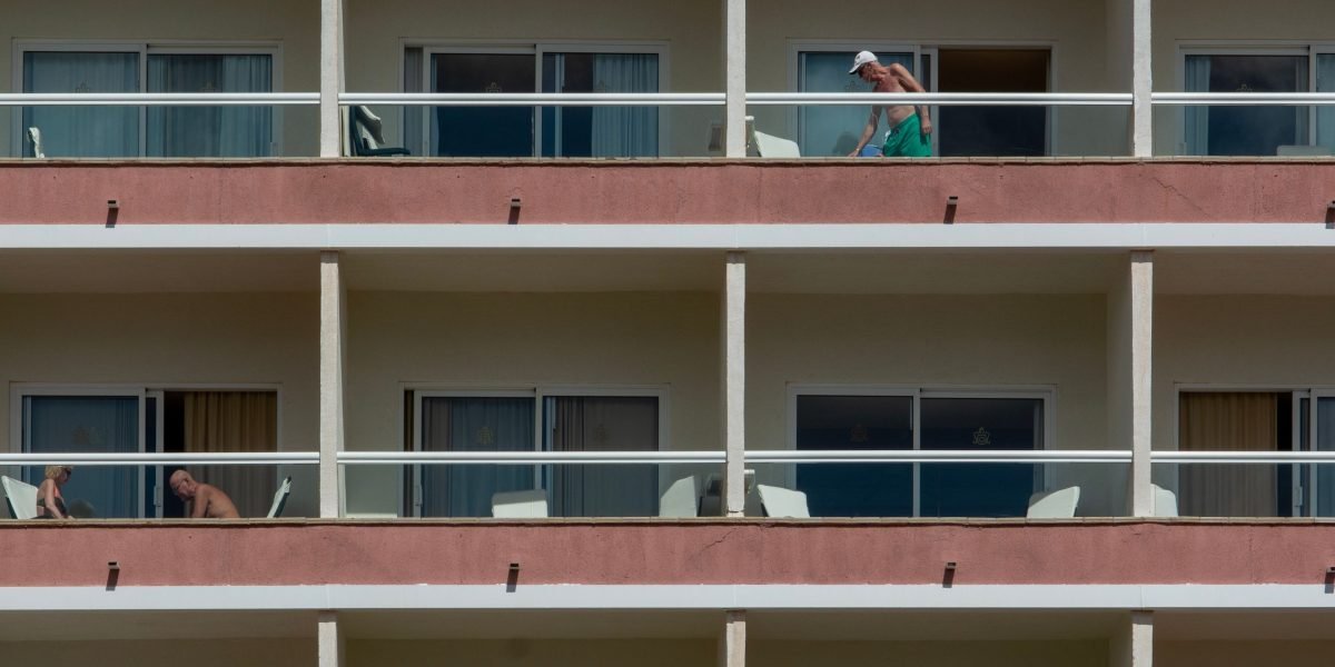 A potential buyer viewing a modern apartment in JBR with a real estate agent.