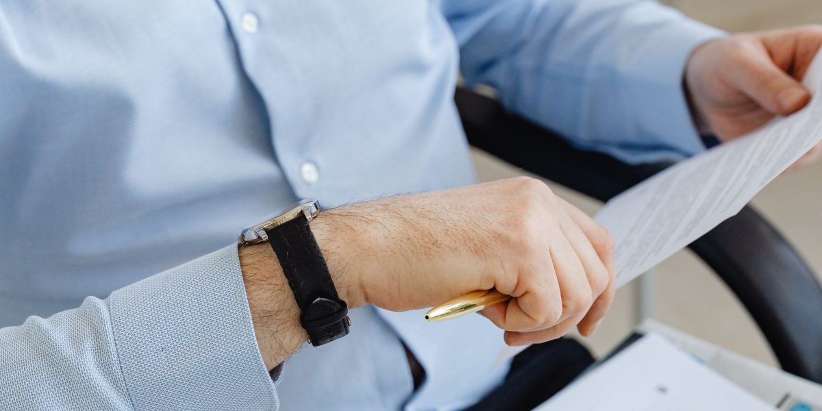 An individual diligently examining property documents, emphasizing the importance of thorough verification.