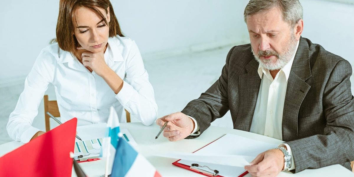 A real estate agent actively listens to a client during a consultation, understanding their specific property needs.