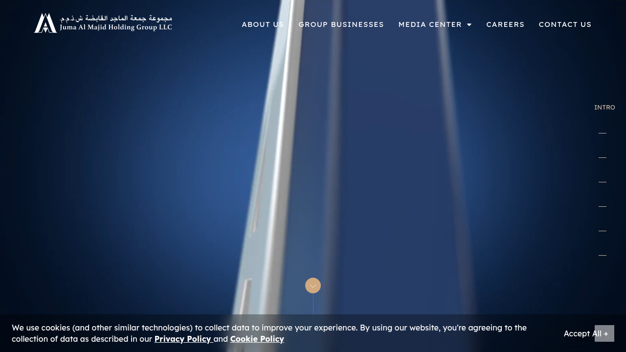 The homepage of Juma Al Majid Holding Group, highlighting its diverse business groups including real estate.