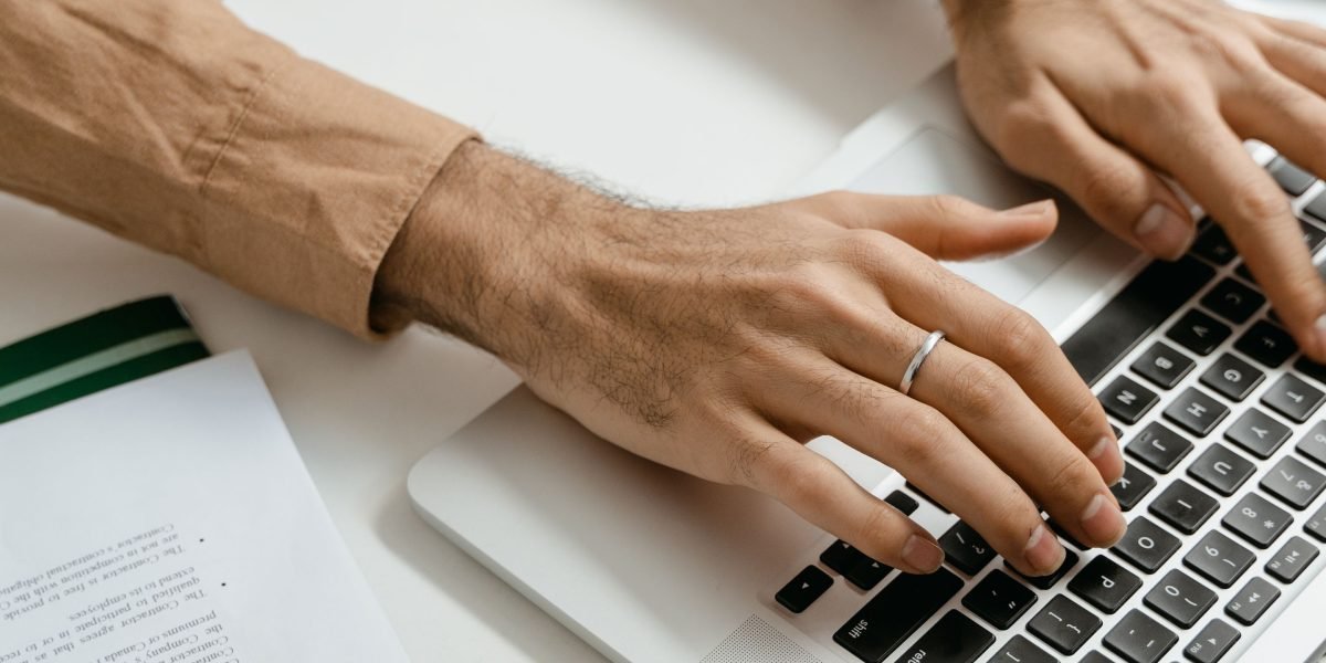 An individual thoughtfully researching property options and real estate companies in Dubai to make an informed decision.
