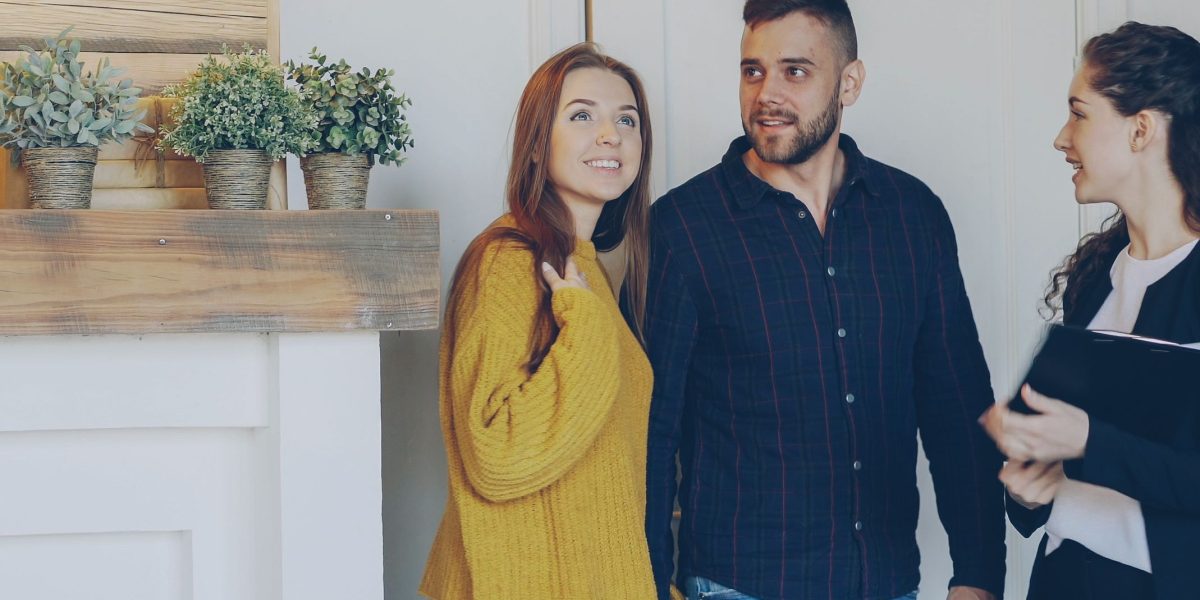 A couple meets with a real estate agent, discussing their property needs and receiving expert guidance.