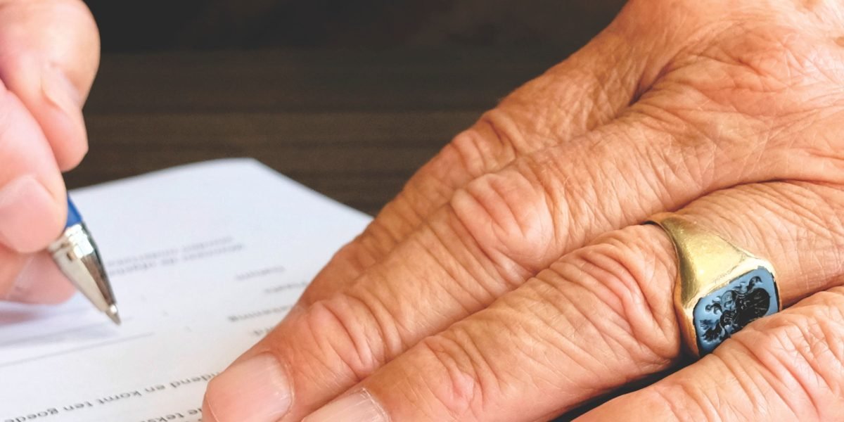 An individual carefully reviewing official documents and licenses to ensure authenticity and trustworthiness.