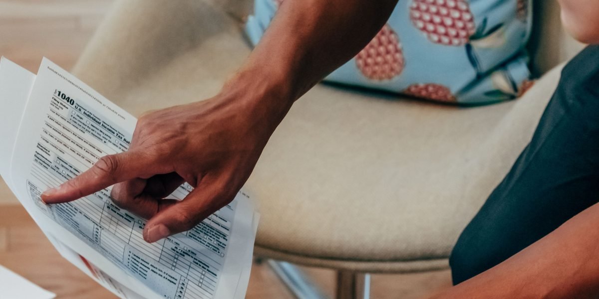 An individual carefully reviewing a financial statement, emphasizing the importance of understanding all costs involved in real estate transactions.