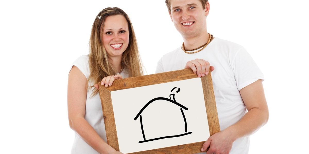 A happy couple celebrating their successful move into a new home, symbolizing the positive outcome of choosing the right real estate agency.