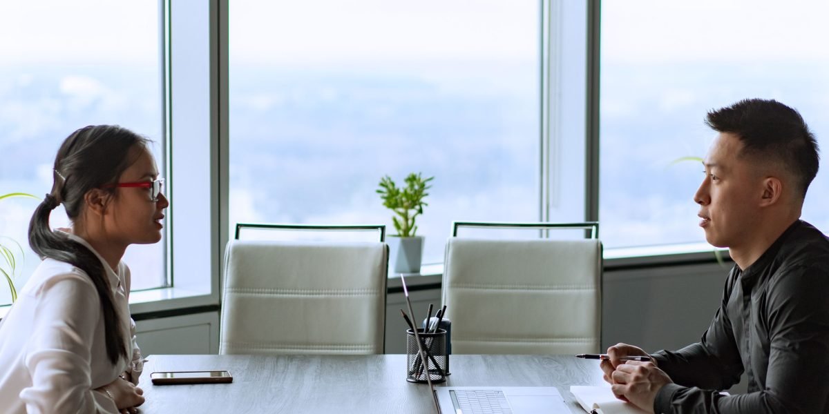 A person engages in a focused conversation, asking questions to assess a potential advisor.